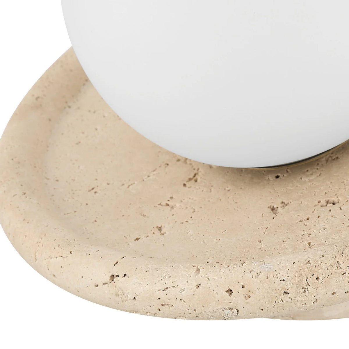 Close-up of a white ceramic bowl on a beige stone surface