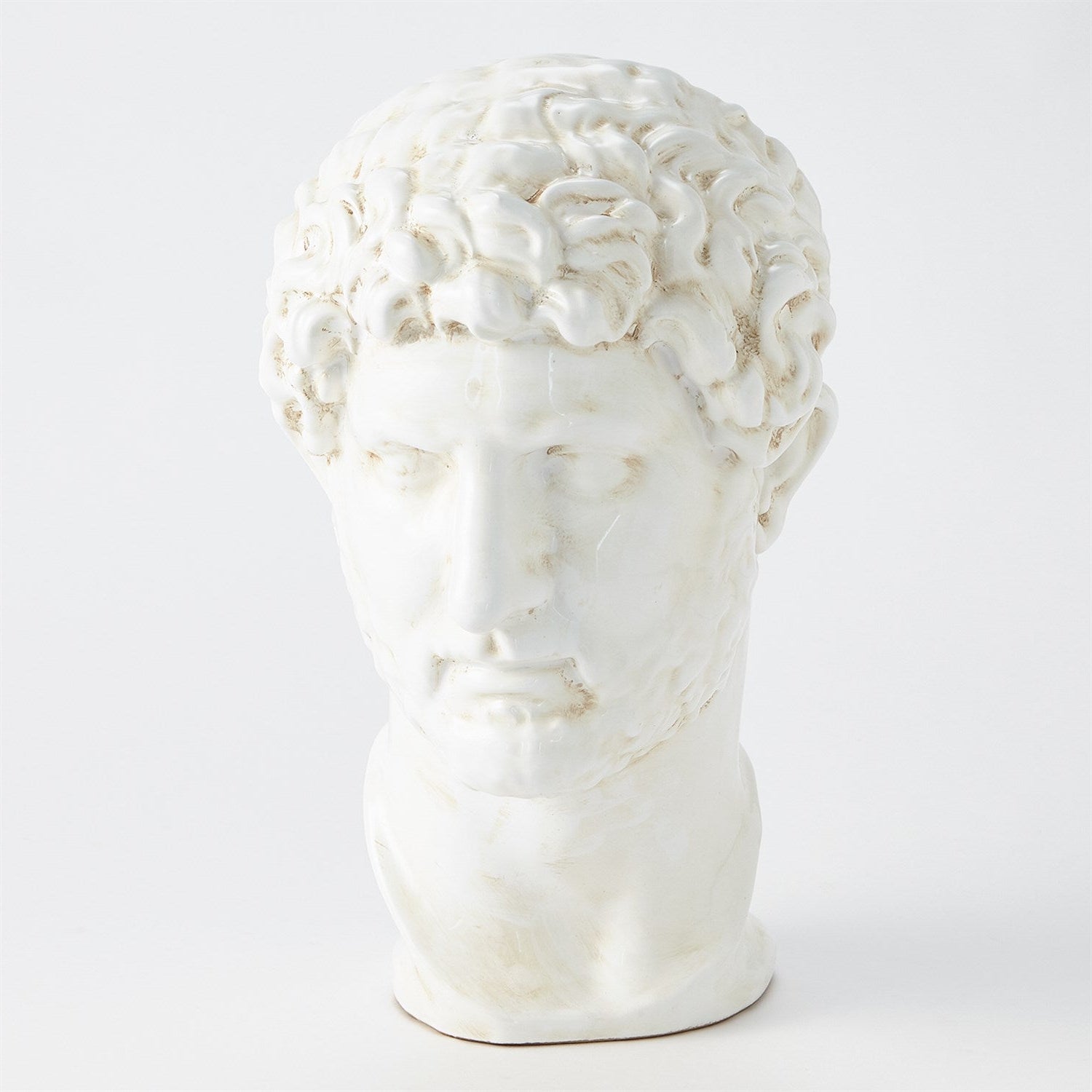 White marble sculpture of a face on a white background