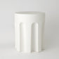 White ceramic side table with arches on a white background