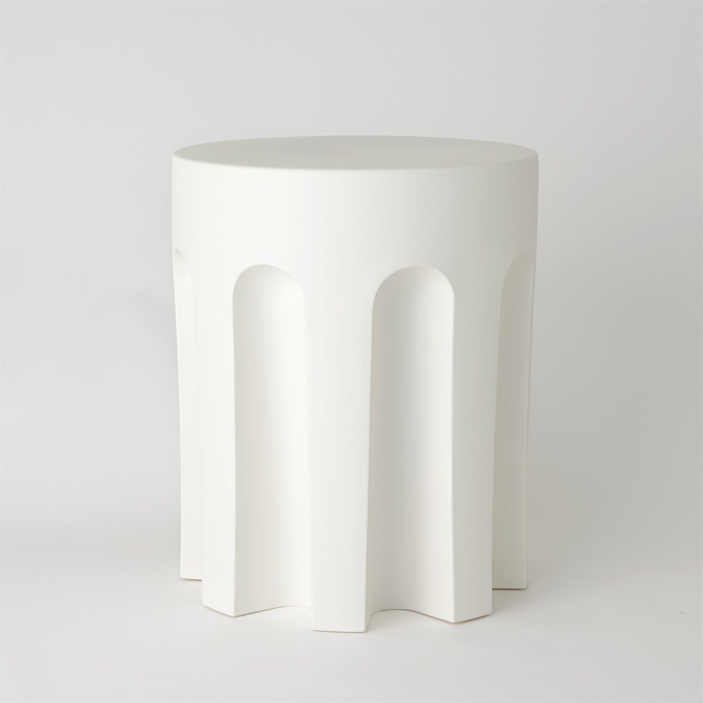 White ceramic side table with arches on a white background