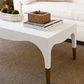 White coffee table with decorative items in a living room setting