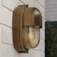 Brass outdoor wall light fixture on a brick wall