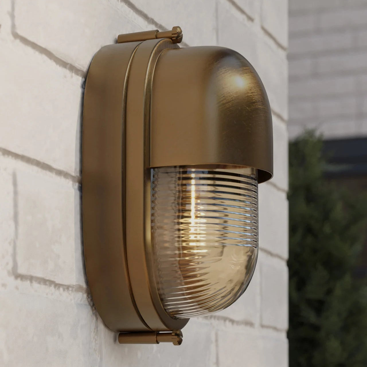 Brass outdoor wall light fixture on a brick wall