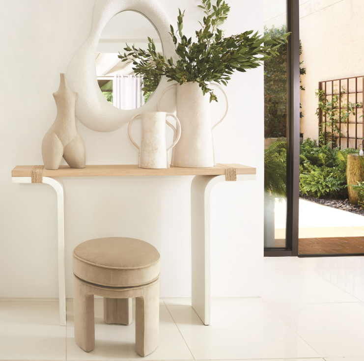 Modern interior with a wooden console table, mirror, and decorative items.