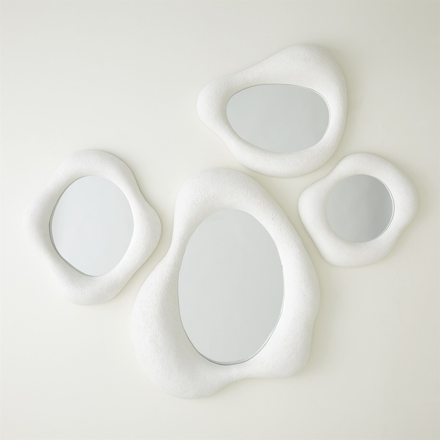 Modern wall mirror lwith four circular lights on a white background