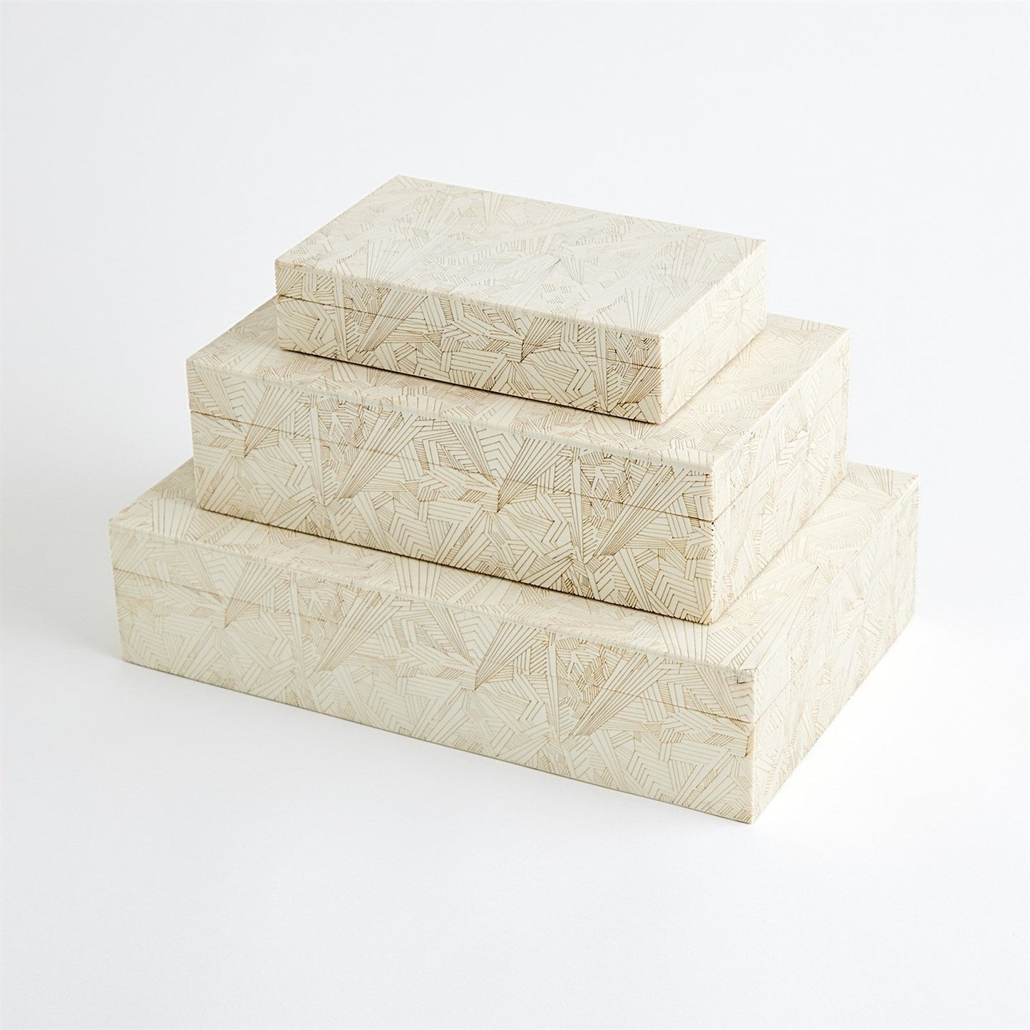 Set of three cream-colored decorative boxes with geometric patterns on a white background