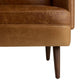 Close-up of a brown leather armchair with wooden legs on a white background