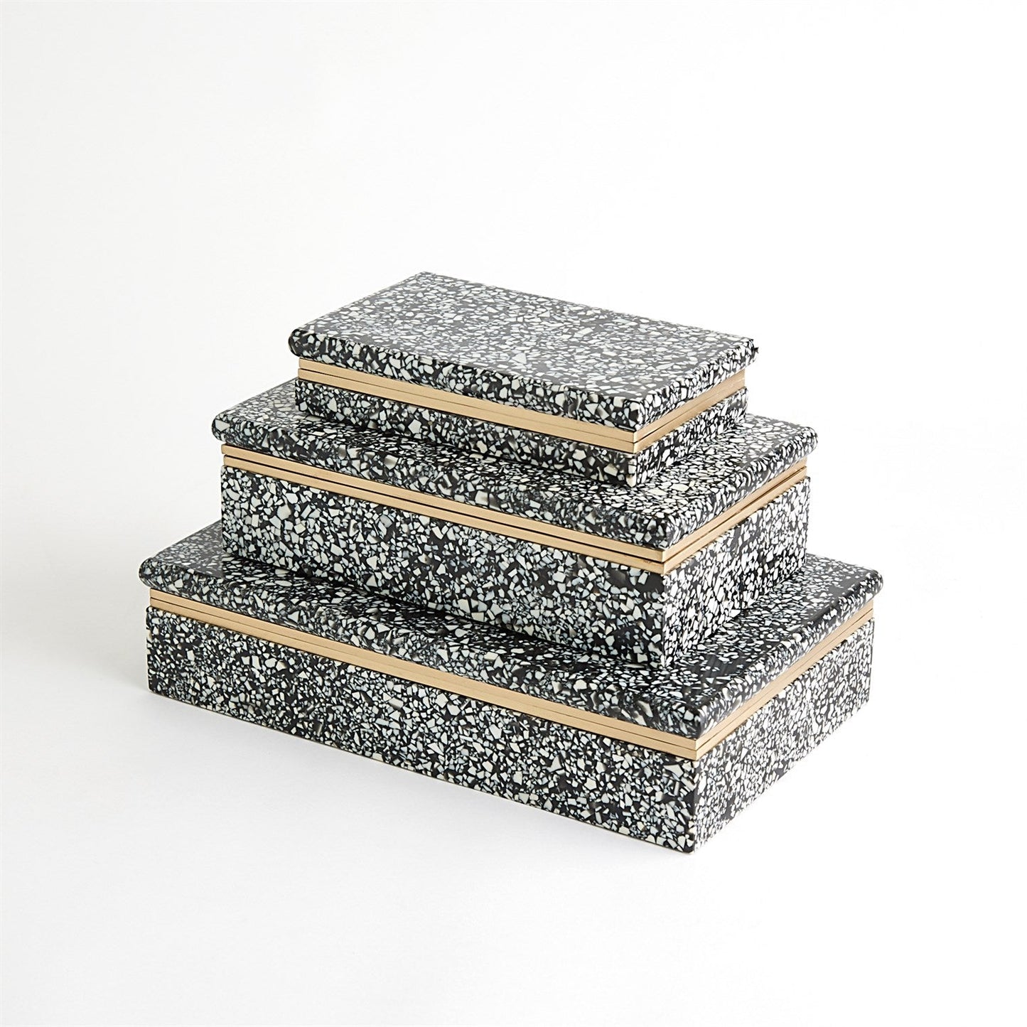 Set of three decorative boxes with black speckled pattern and wooden edges on a white background