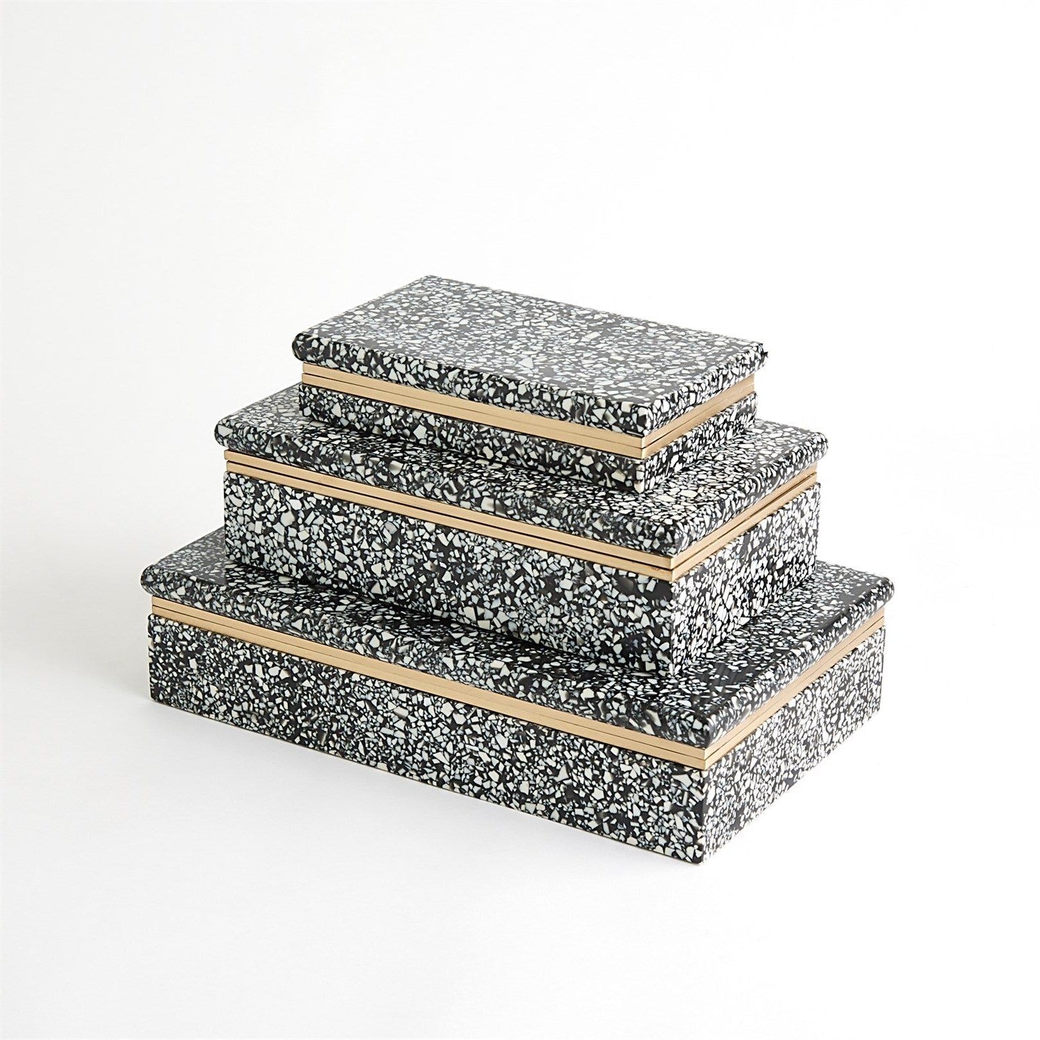 Set of three decorative boxes with black speckled pattern and wooden edges on a white background