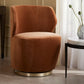 Brown velvet swivel chair in a room with a table and decorative elements.