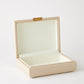 Beige jewelry box with a clear lid on a white background