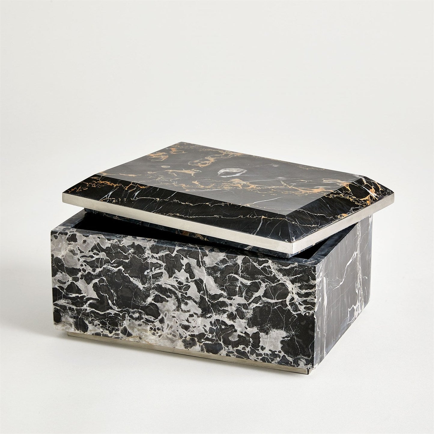 Marble-patterned jewelry box with a black and gold lid on a white background