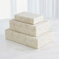 Three stacked decorative boxes with a geometric pattern on a white background