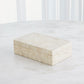 Rectangular marble box on a white surface with a blurred white background