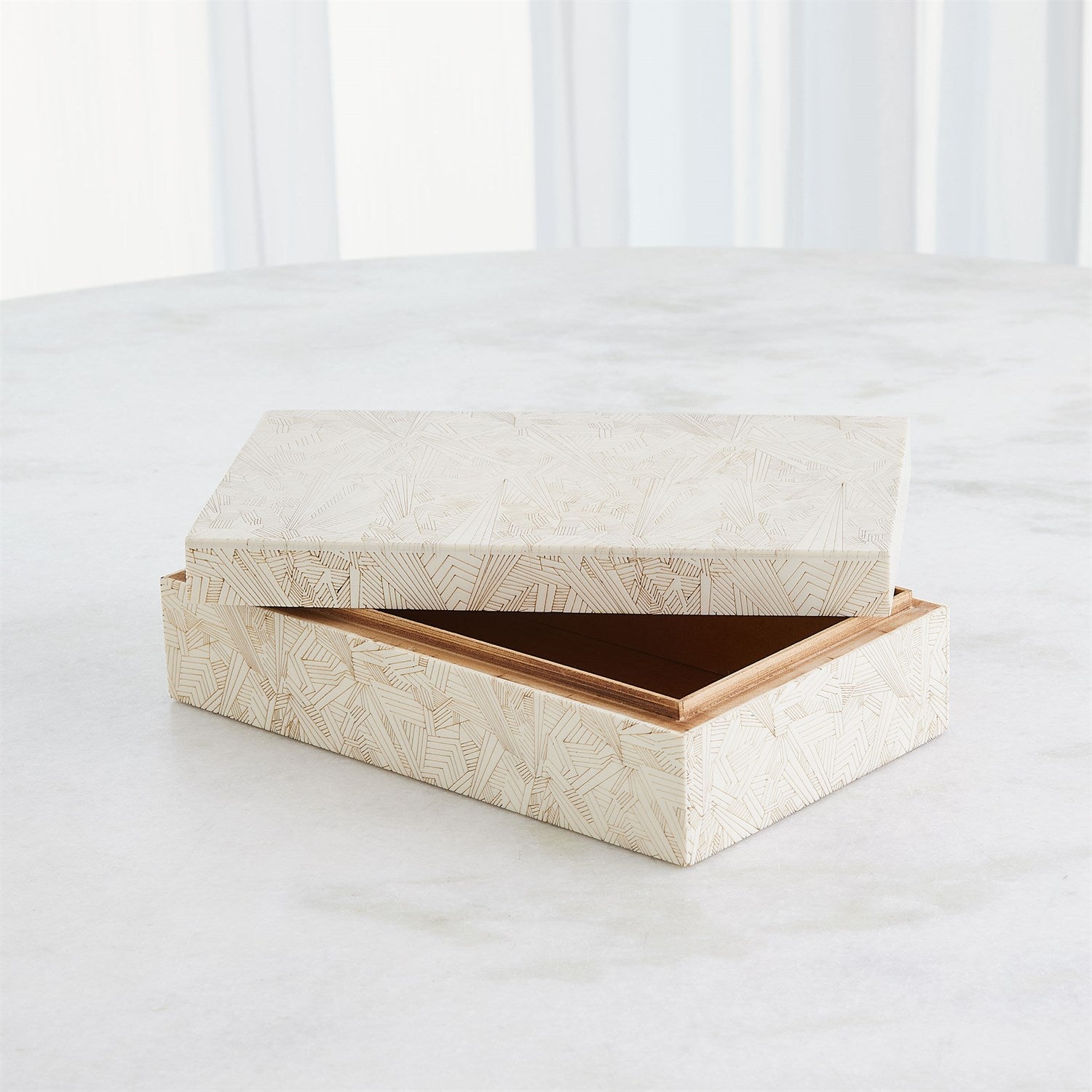 Wooden box with a geometric pattern on a white surface