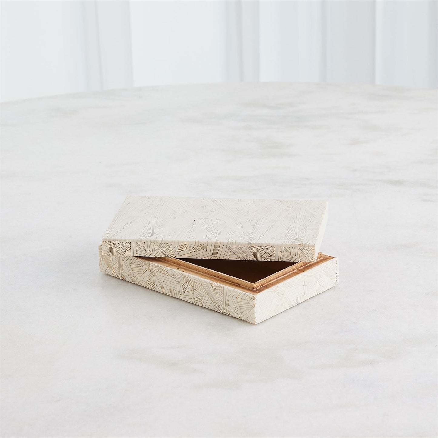 Wooden jewelry box with a textured surface on a white background