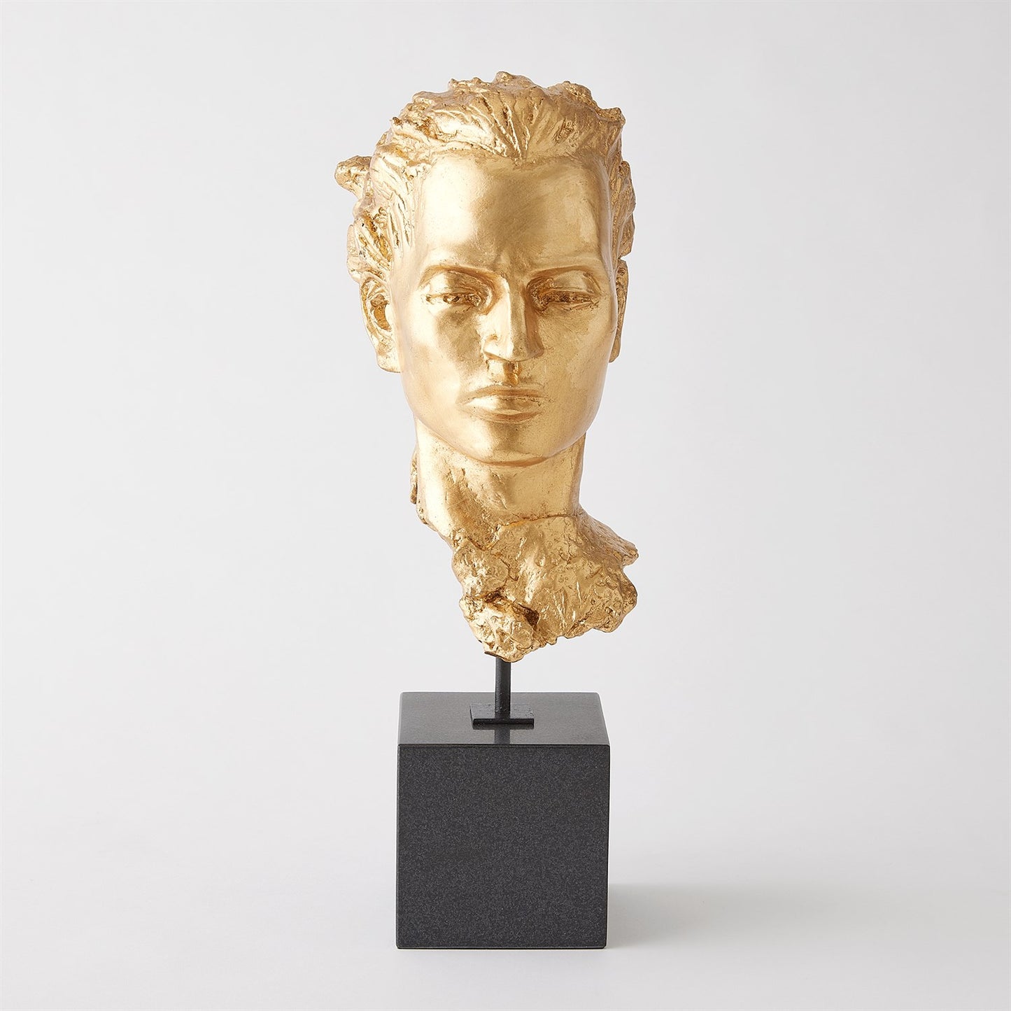 Gold-colored bust on a black pedestal against a white background