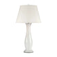 A table lamp with a tapered off-white fabric shade and a sculptural, fluted glass base in white and clear glass, set against a plain white background.