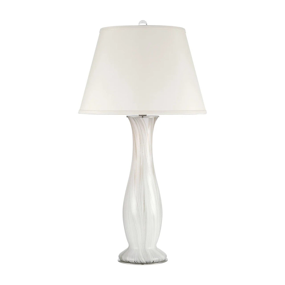 A table lamp with a tapered off-white fabric shade and a sculptural, fluted glass base in white and clear glass, set against a plain white background.