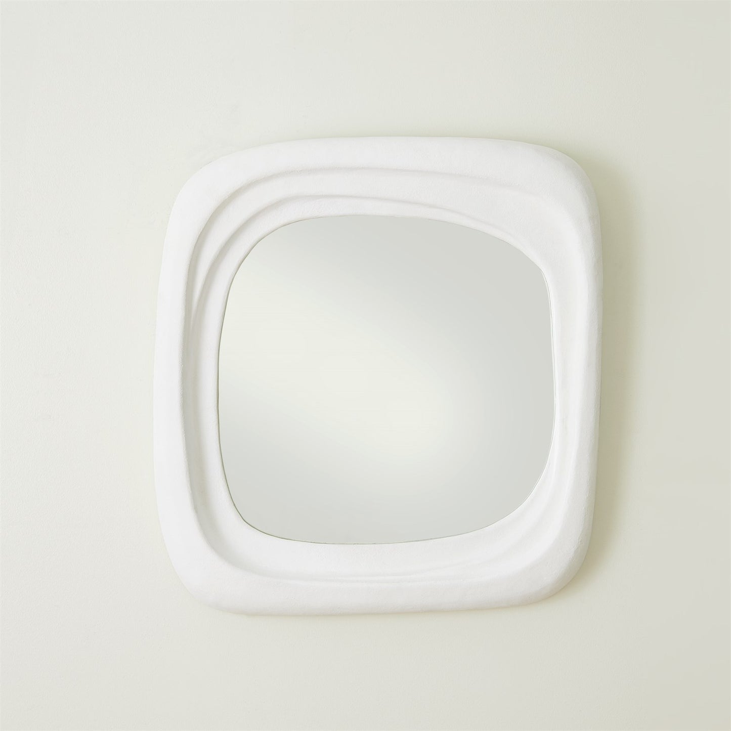 White square mirror on a light beige wall