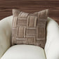 Brown woven pillow on a white chair with a wooden background
