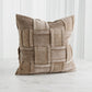 Beige woven pillow on a white background