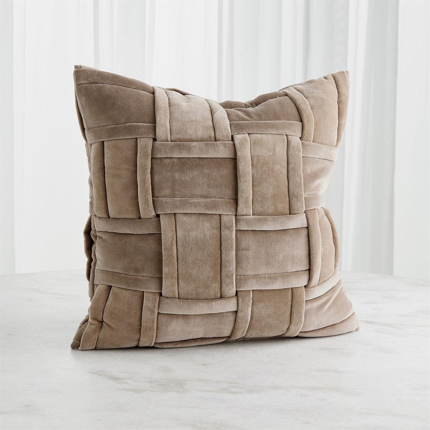 Beige woven pillow on a white background
