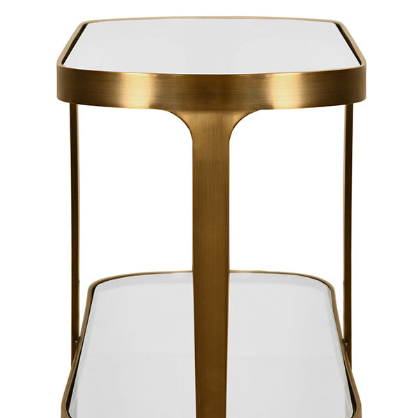 Gold-framed side table with white glass top and shelves on a white background