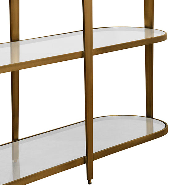 Three-tiered shelf with glass shelves and gold metal frame on a white background