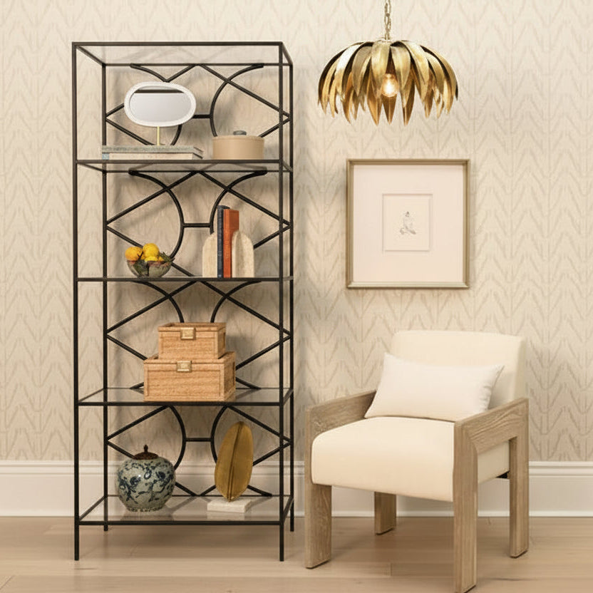 Decorative room interior with a black metal shelf, beige armchair, and gold pendant light.