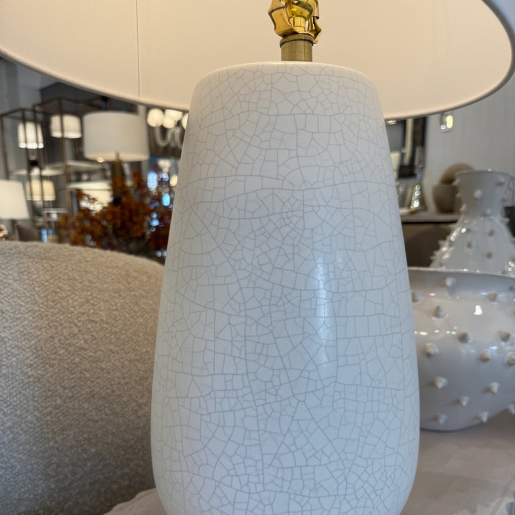 White ceramic lamp with textured surface on a table