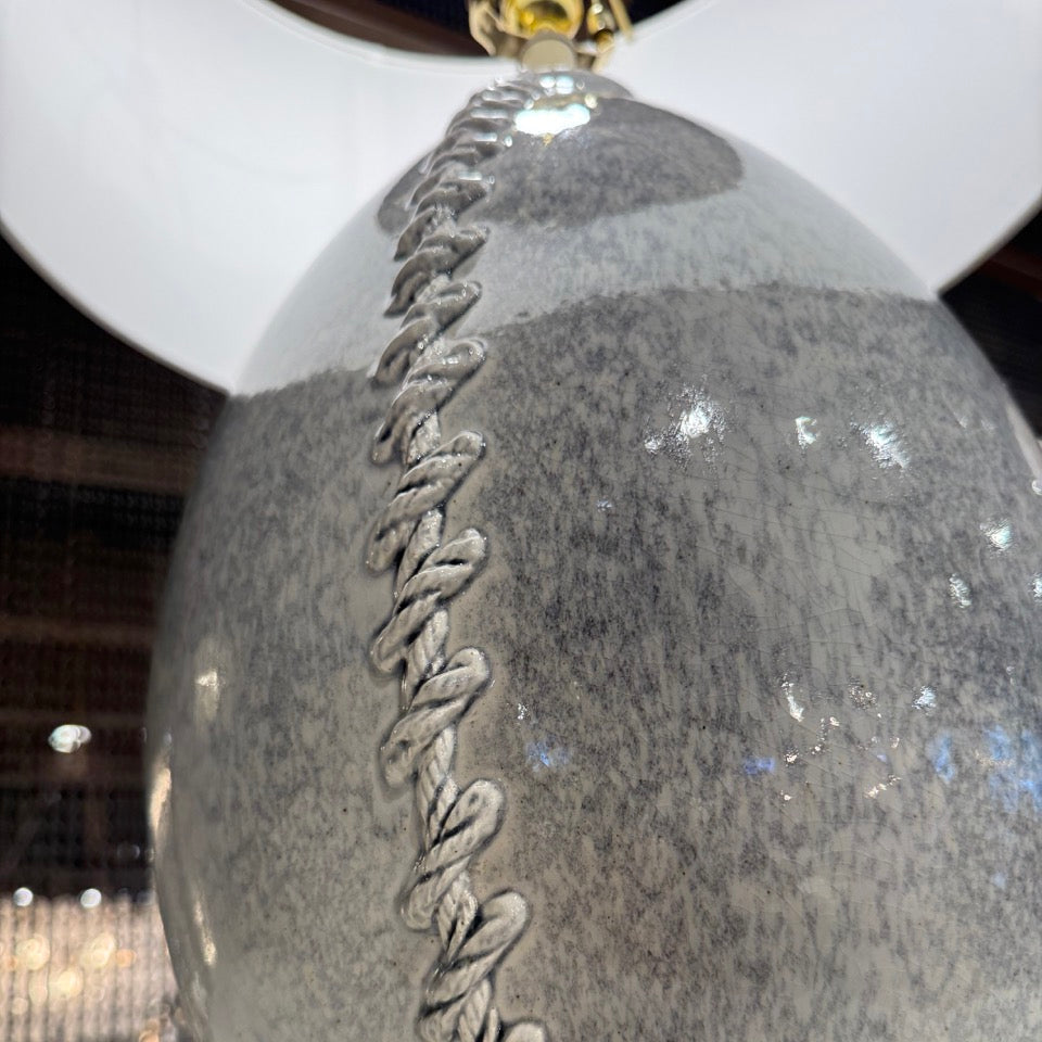 Close-up of a decorative lamp with a textured design on a blurred indoor background