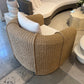 Wicker chair with white cushions in a showroom setting
