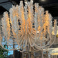 Decorative chandelier hanging in a room with large windows