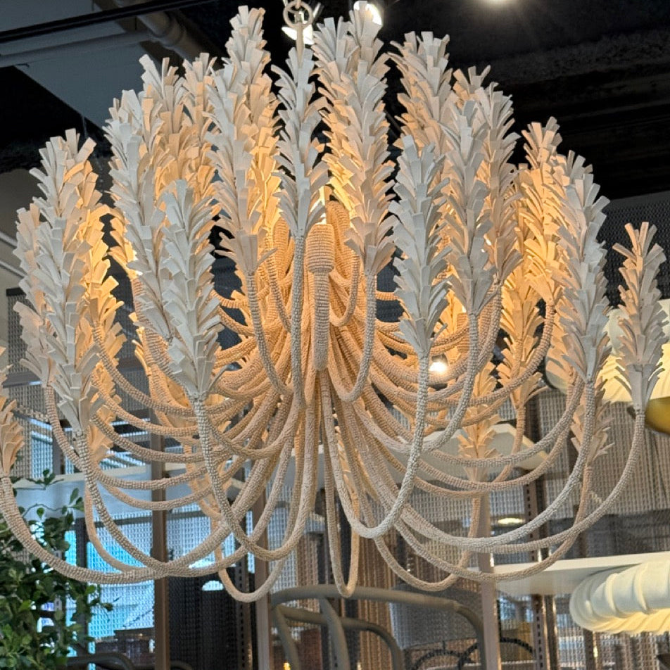 Decorative chandelier hanging in a room with large windows