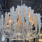 Large white chandelier in a showroom setting