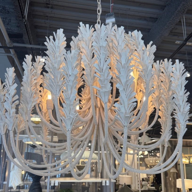 Large white chandelier in a showroom setting