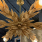 Gold leaf chandelier hanging from the ceiling
