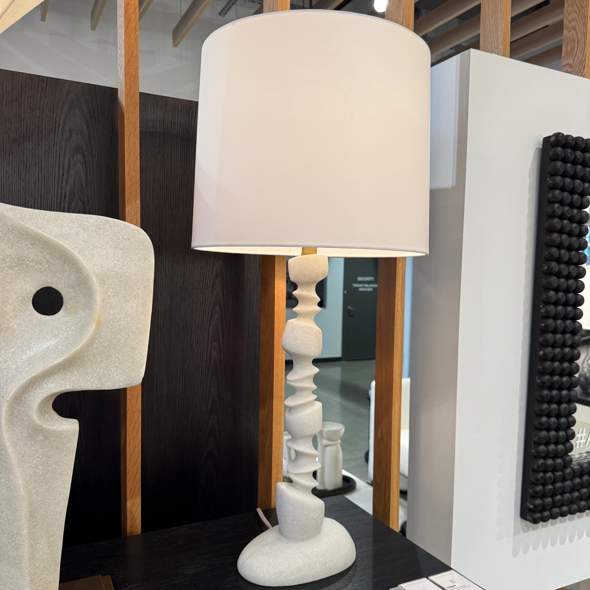 White table lamp on a dark surface with a blurred background