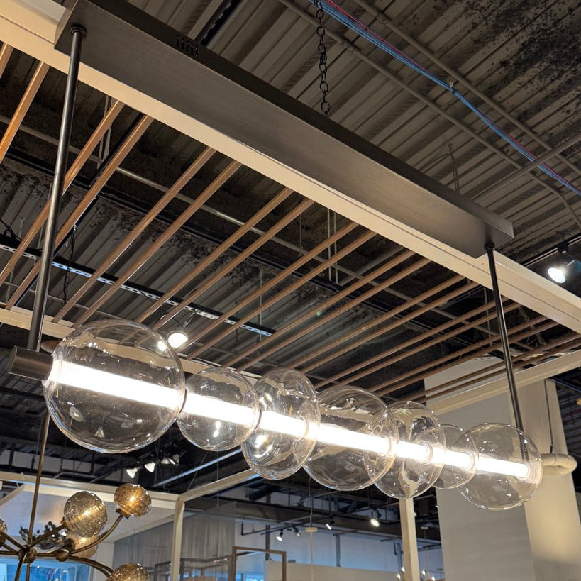 Modern chandelier with glass globe lights hanging from a ceiling