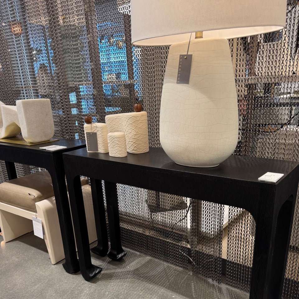 Decorative table with a lamp and vases in a showroom setting