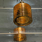 Gold metallic pendant light on a reflective surface