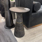 Dark gray side table with gold accents in a room with furniture
