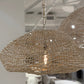 Woven pendant light with 'NEW' tag in a store setting