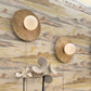 Decorative wall lights and a table lamp on a cabinet against a marble-patterned wall.