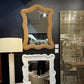 Decorative mirrors with unique frames on a dark wall.