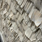 Close-up of a textured wall with wavy stone patterns
