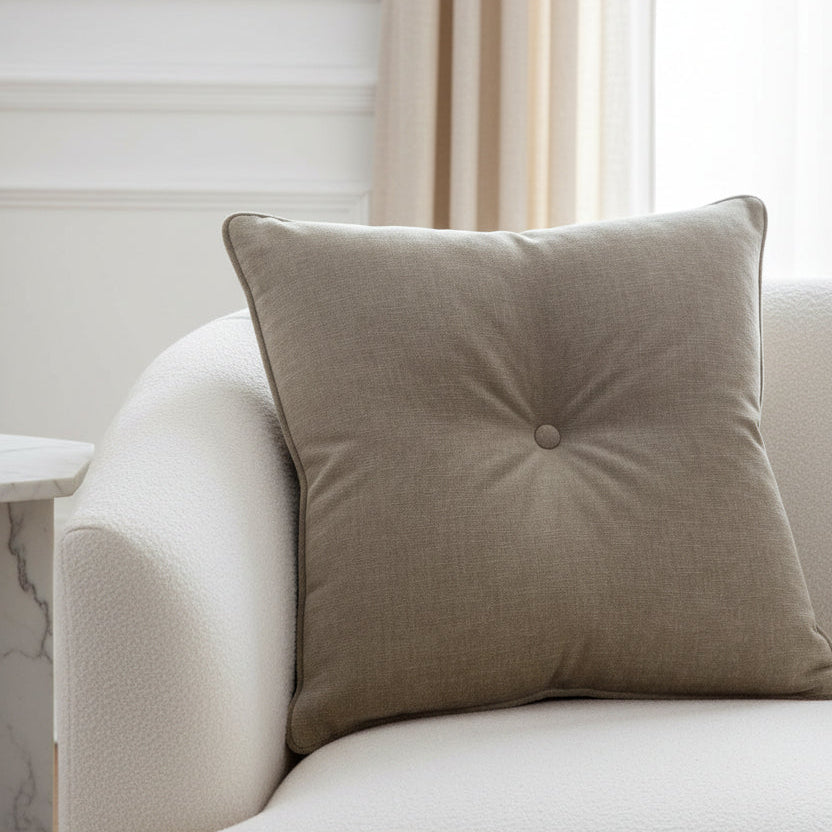 Brown pillow with a button on a white background