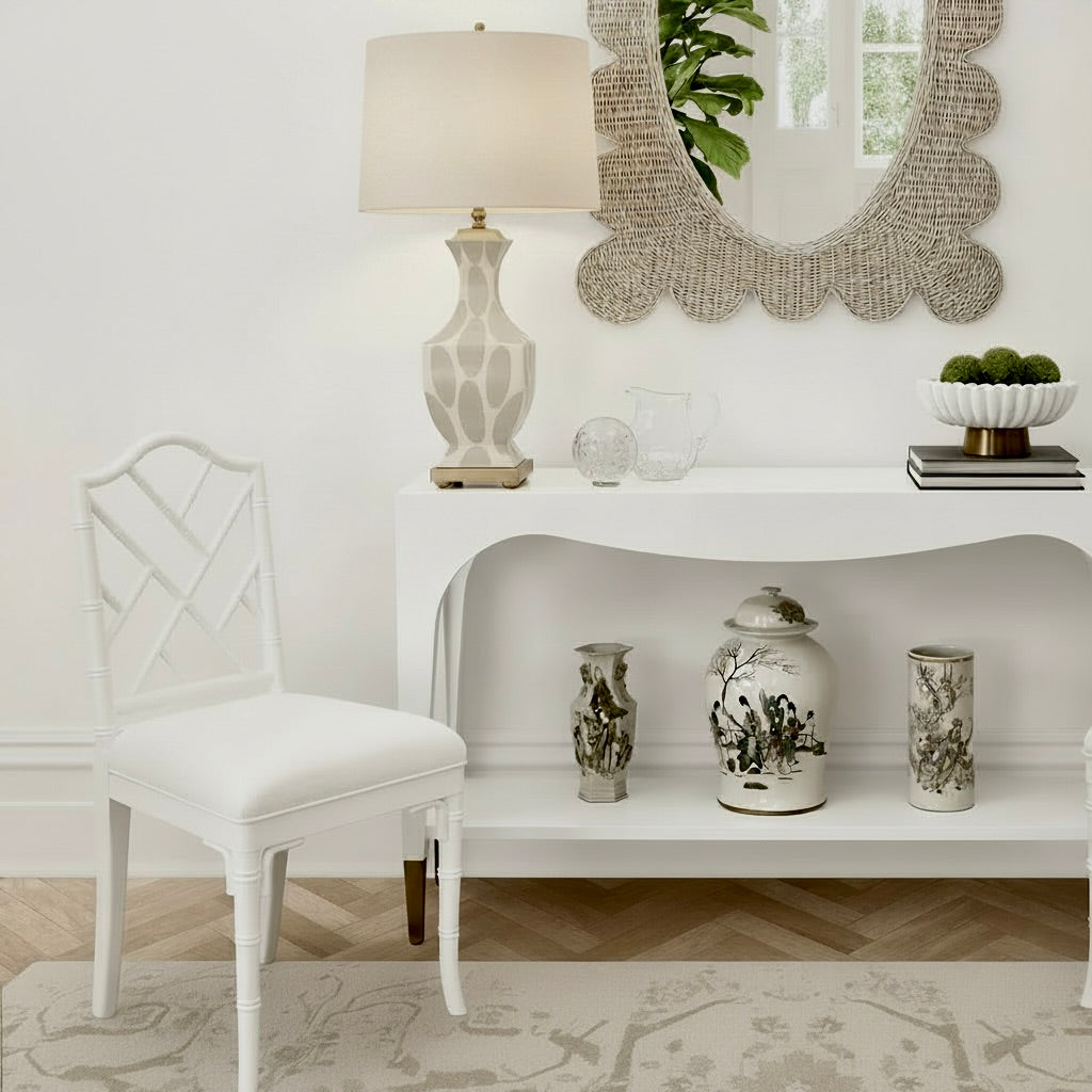 Decorative interior setting with a white chair, lamp, and table with decorative items.