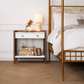 Bedroom with a wooden nightstand and bed featuring white bedding.